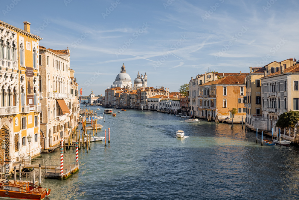Beautiful view on Grand Canal from Accademia bridge with San Giorgio Maggiore church on the background in Venice. Italian landmarks and traveling Italy concept. Cityscape in autumn sunny day