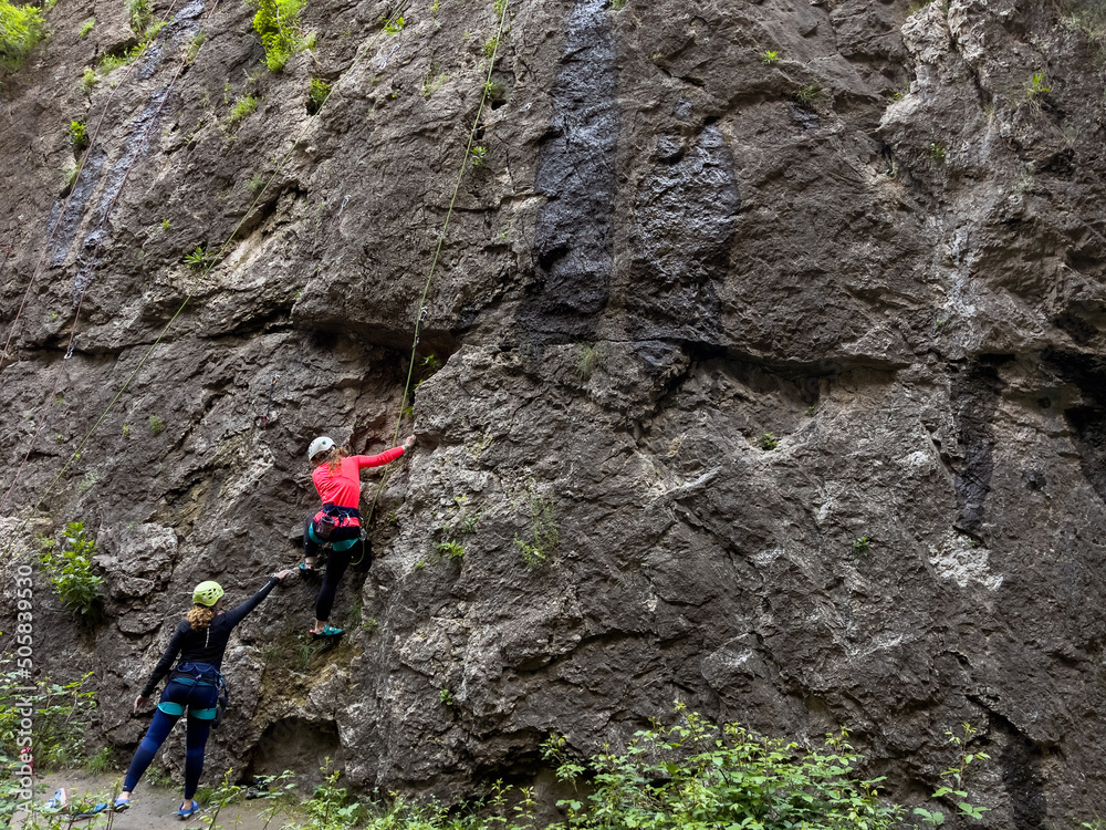 Climber people climbing a natural rocky wall. Extreme sports, healthy lifestyle and adventure concept. Climber people climbing a natural rocky wall. Extreme sports, healthy lifestyle and adventure concept.