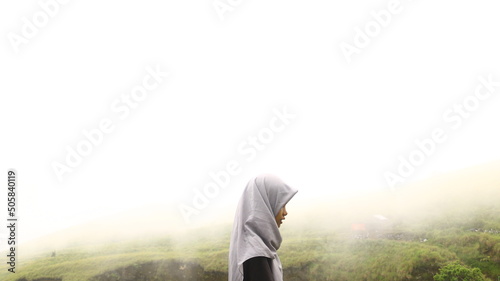 woman standing surrounded by fog in Rinjani