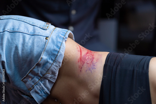Woman with tattoos on body after stuffing a tattoo in the tattoo studio