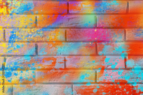 Abstract colorful graffiti drawn on brick wall