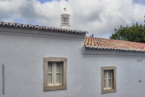 Traditional openwork chimney on a roof in Almancil, Algarve, Portugal photo