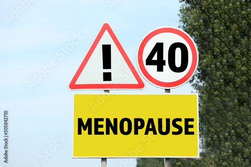 Concept of impending menopause at 40 years old. Post with dIfferent signs outdoors