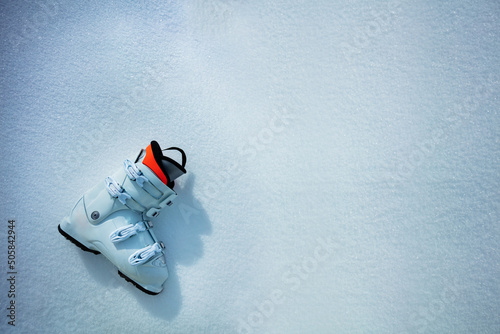 Alpine ski boot in snow from above - mountains vacation concept photo