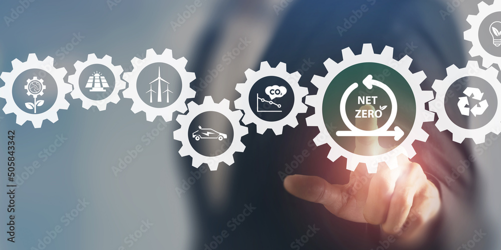 Net zero , zero emissions concept. Carbon neutral. Greenhouse gas emissions target. Climate neutral long term strategy. Businessman touching on net zero icon on smart background. Net zero , zero emissions concept. Carbon neutral. Greenhouse gas emissions target. Climate neutral long term strategy. Businessman touching on net zero icon on smart background.