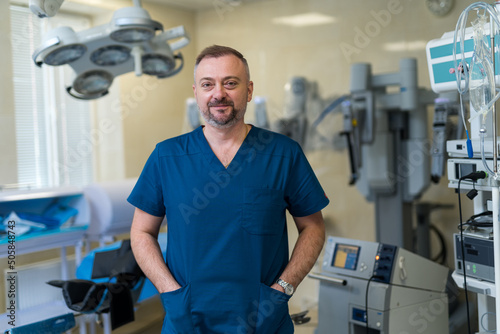 Portrait of professional surgeon in emergency room. Surgery specialist in uniform standing in hospital.