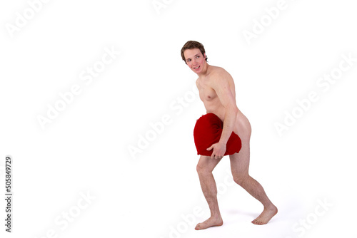 Romantic topless man holding a red heart in his hands while standing on a white background. Valentine's Day and gifts. Isolate.