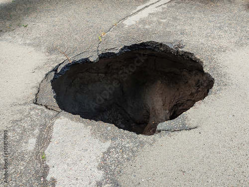 Large hole in the asphalt, sinkhole photo