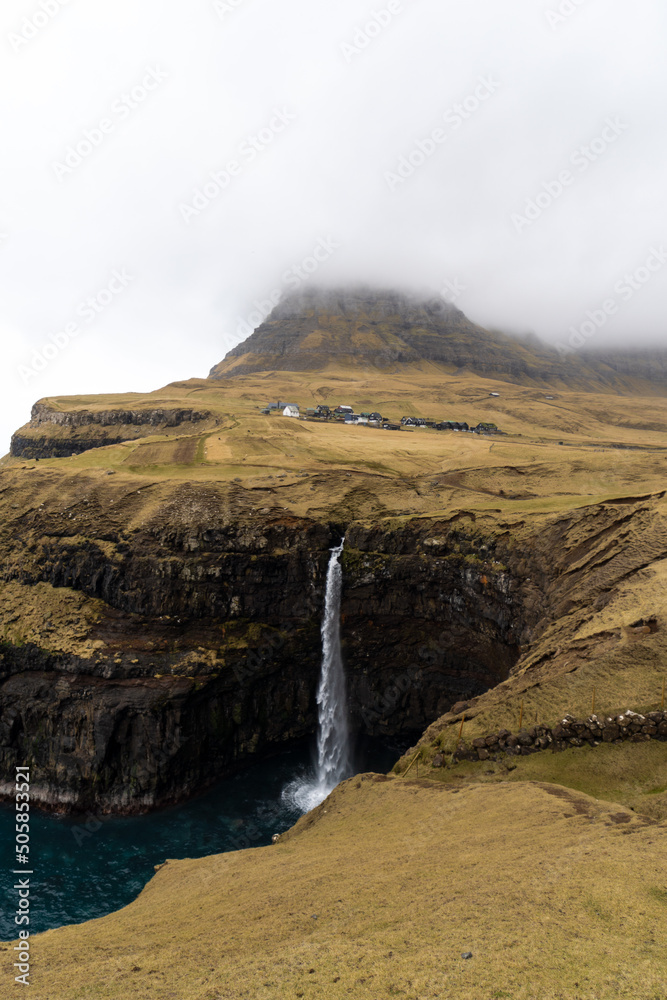view of Múlafossur Waterfall in Gasadalur Village, Vagar - Faroe Islands