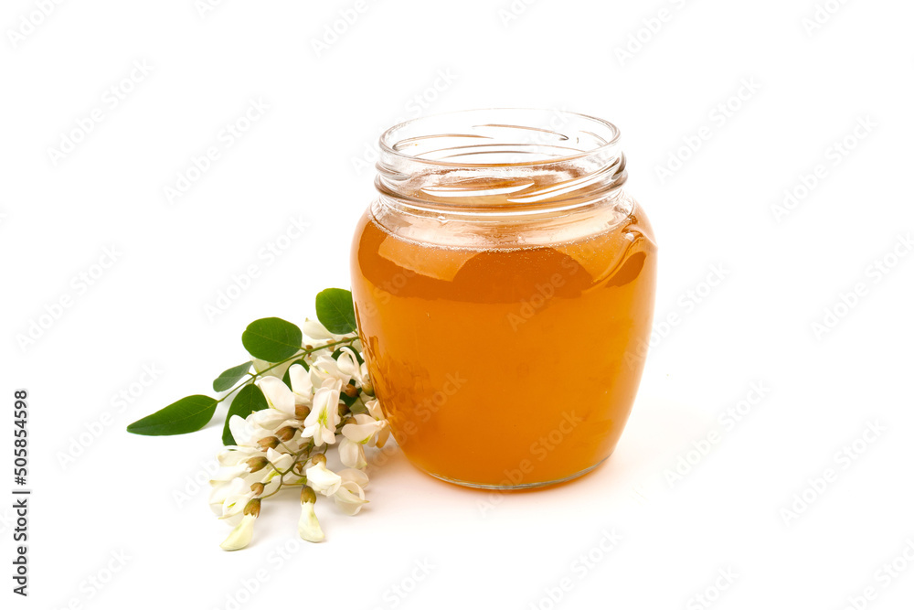 Jar of honey with flowers of acacia isolated on white background Jar of honey with flowers of acacia isolated on white background