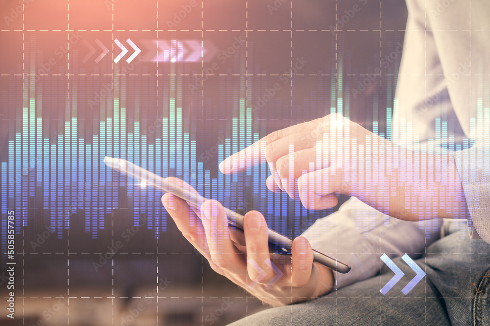 Double exposure of man's hands holding and using a digital device and forex graph drawing. Financial market concept. Double exposure of man's hands holding and using a digital device and forex graph drawing. Financial market concept.