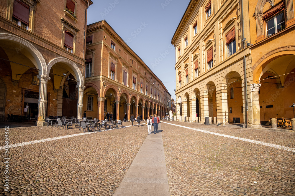 Morning view on Seven churches square in old town of Bologna city. Ancient buildings with galleries in Emilia Romagna region in Italy
