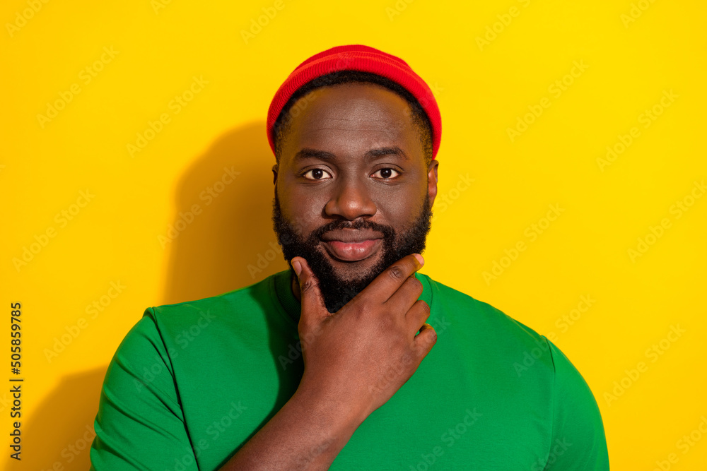 Portrait of attractive bewildered guy touching unshaven beard overthinking isolated over bright yellow color background Portrait of attractive bewildered guy touching unshaven beard overthinking isolated over bright yellow color background