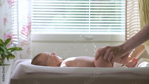 A baby boy suddenly starting to pee during a diaper change