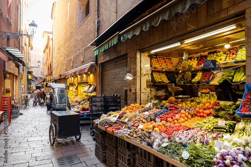 Fototapeta Naklejka Na Ścianę i Meble -  Gastronomical street with market stalls full of fresh local fruits and vegetables in Bologna, Italu