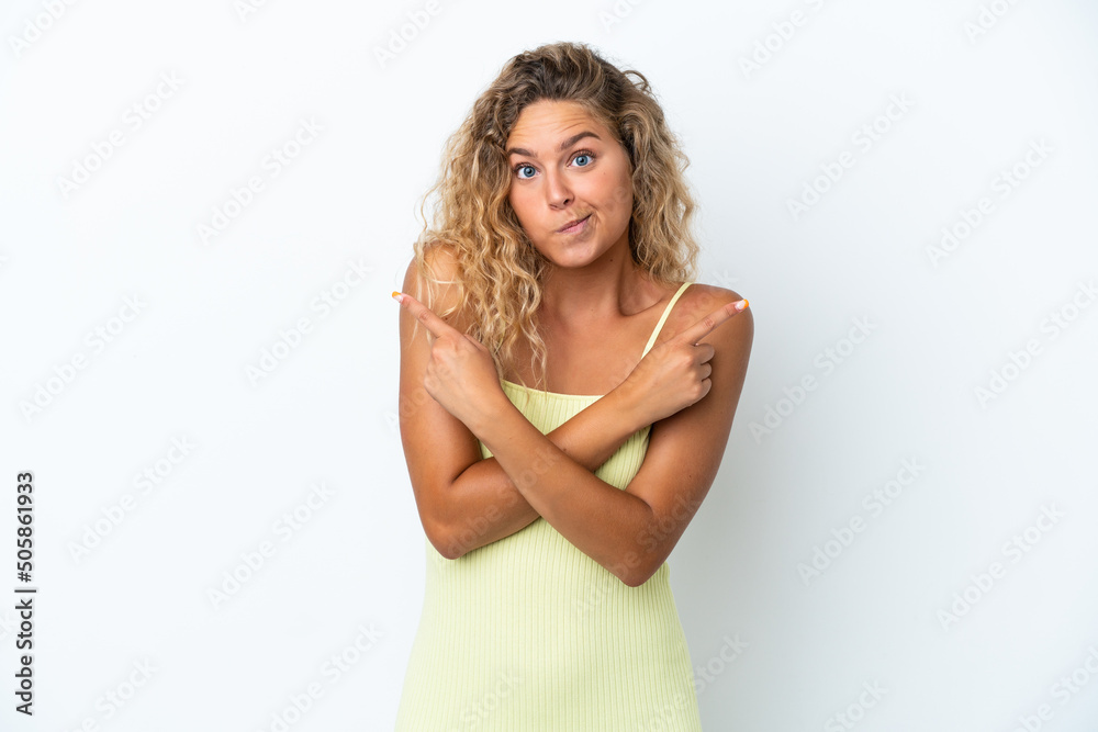 Girl with curly hair isolated on white background pointing to the laterals having doubts Girl with curly hair isolated on white background pointing to the laterals having doubts