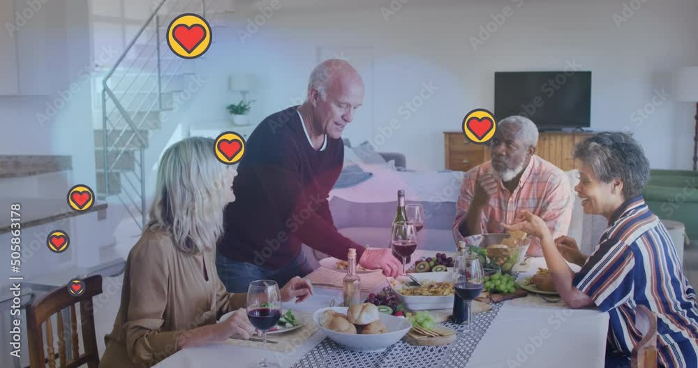 Animation of hearts over diverse group of seniors eating Animation of hearts over diverse group of seniors eating