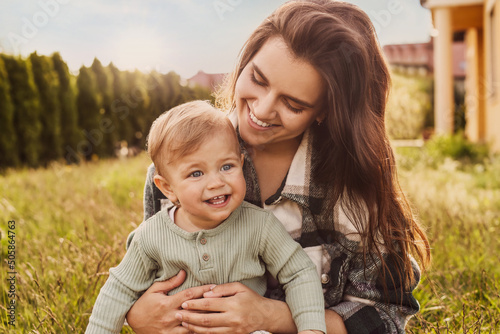 Εκτύπωση καμβά Happy mother with her cute baby at backyard on sunny day