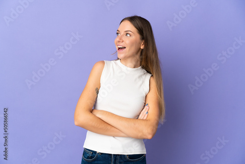 Young Lithuanian woman isolated on purple background happy and smiling