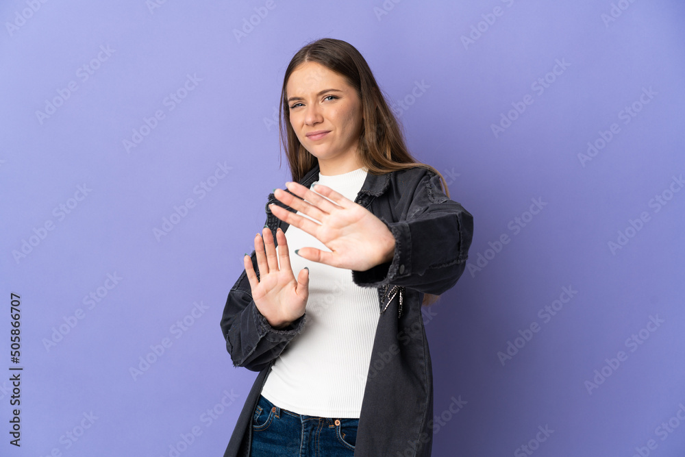 Young Lithuanian woman isolated on purple background nervous stretching hands to the front Young Lithuanian woman isolated on purple background nervous stretching hands to the front