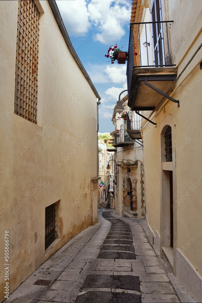A narrow street of Modica, an old town of Sicily region, Italy.