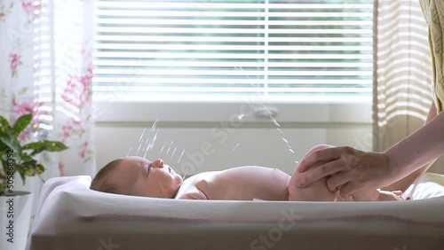 A baby boy suddenly starting to pee during a diaper change