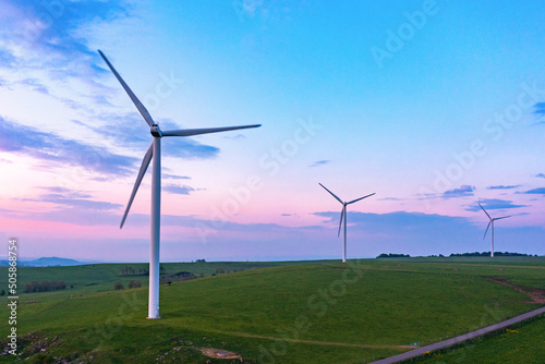 Drone view of some wind turbines at sunset