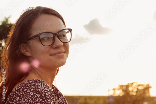 Quadro em tela Portrait of a beautiful brown-haired young woman in glasses at sunset