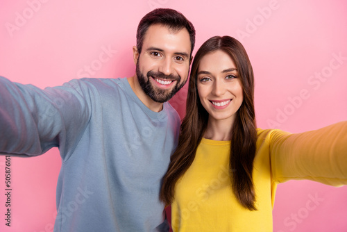 Portrait of two positive nice partners make selfie record video toothy smile isolated on pink color background