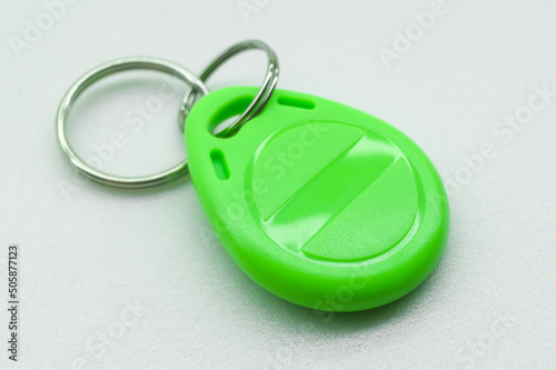 RFID tag key chain. Plastic cloned non-contact electronic radio key for intercom. NFC tag. Selective focus photo