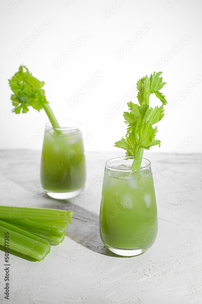 celery juice in glass on white background