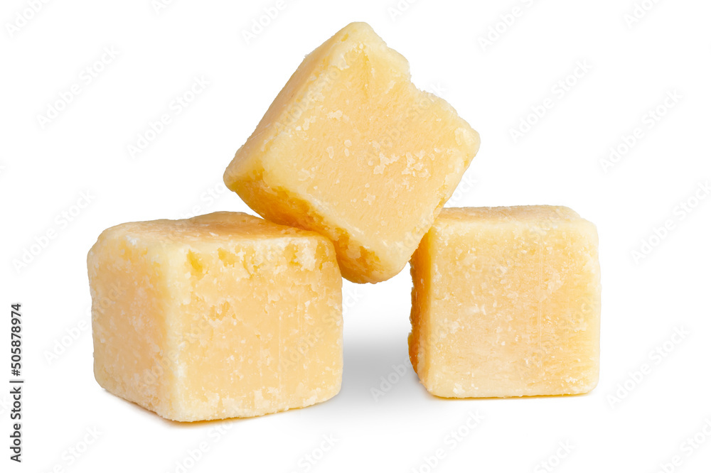 Parmesan grana padano cheese cubes isolated on white .