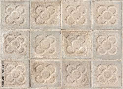 Barcelona pavement tiles with a flower, panot slabs with symbol  texture top view photo