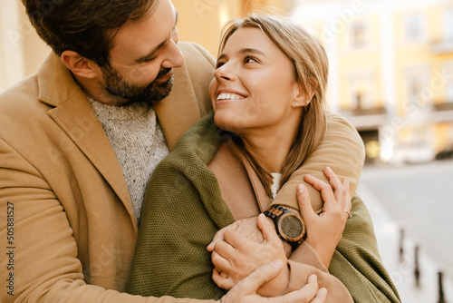 Photos White romantic couple smiling and hugging outdoors