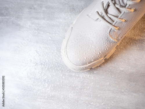 Water droplets on winter shoe protected with waterproof spray  photo