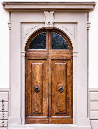 Elegant front door - Old-fashioned portal of an historical building with brick arch.