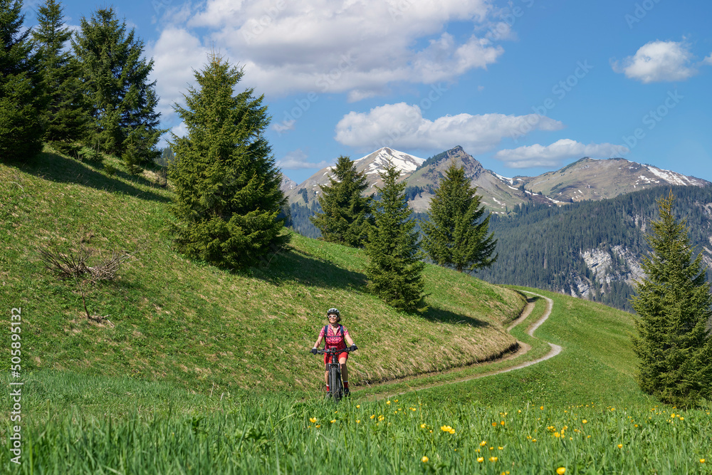 nice senior woman riding her electric mountain bike in the Lech Valley mountains near Reutte in Tirol, Austria nice senior woman riding her electric mountain bike in the Lech Valley mountains near Reutte in Tirol, Austria