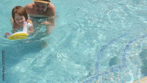 Kid father pool child swimming pool happy dad and daughter playing water summer fun family hugging. Parent and child dad pool kid swimming family summer holiday children learning swimming lessons kids
