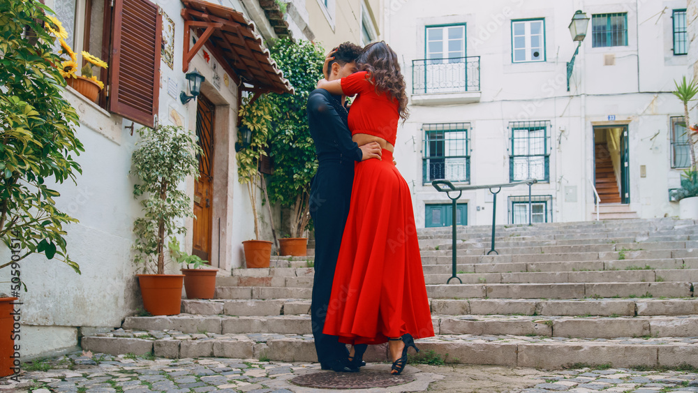 Beautiful Couple Dancing a Latin Dance on the Quiet Street of an Old Town in a City. Sensual Dance by Two Professional Dancers on a Sunny Day Outside in Ancient Culturally Rich Tourist Location. Beautiful Couple Dancing a Latin Dance on the Quiet Street of an Old Town in a City. Sensual Dance by Two Professional Dancers on a Sunny Day Outside in Ancient Culturally Rich Tourist Location.