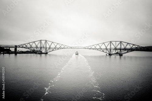 Forth Bridge with container ship underneath - B&W toned image. Edinburgh Scotland (ID: 505902150)