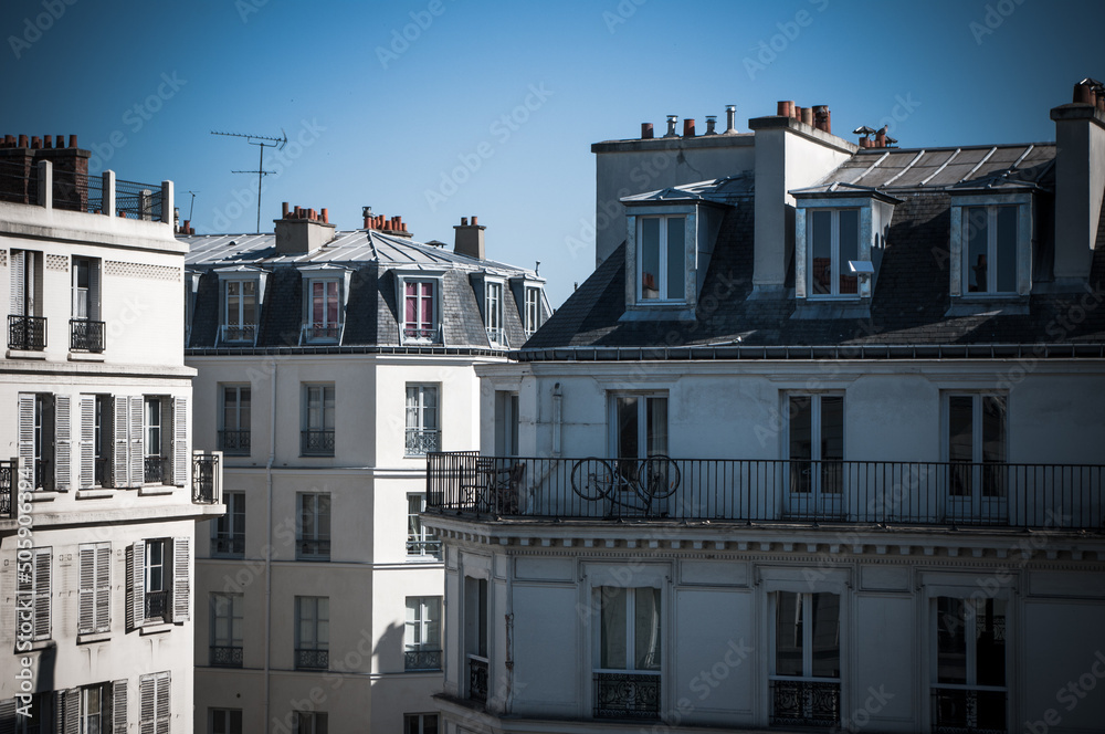 Obraz premium Parisian Rooftops with bikes on sunny blue sky day