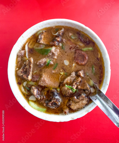 Coto Makassar or beef soup, traditional culinary from Makassar, South Sulawesi, Indonesia. photo