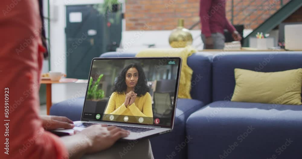 Biracial businesswoman using laptop for video call with biracial business colleague Biracial businesswoman using laptop for video call with biracial business colleague