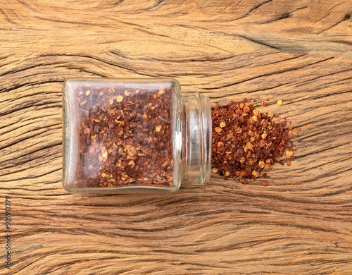 Top view, closeup of dried red calabrian pepper on a glass pot photo