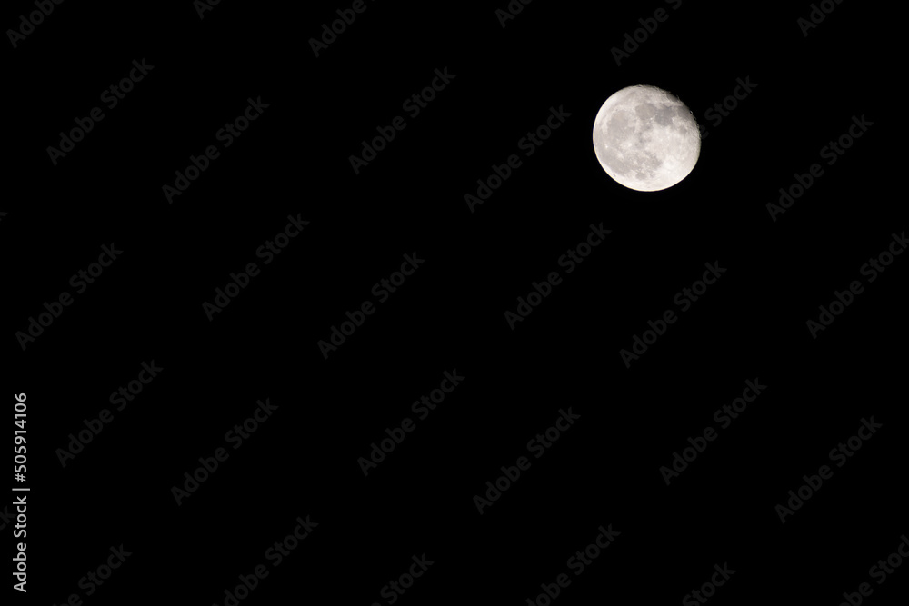Moon in the black night sky at 92 percent illumination on waning gibbous Moon in the black night sky at 92 percent illumination on waning gibbous