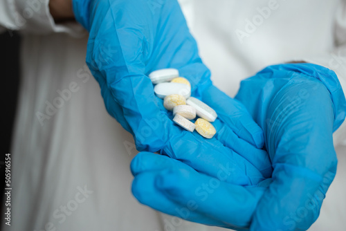 Pour the pills into the hands with a medical glove