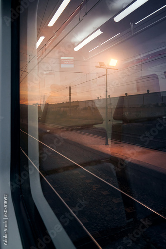 View from a window of a train station at sunset