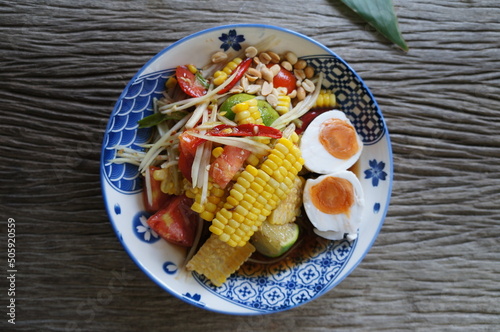 Papaya salad on a wooden table