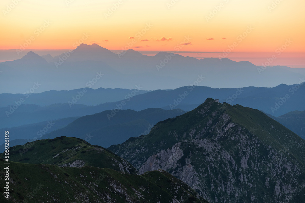 Sunrise mountains silhouette in the Julian Alps. Beautiful morning at the summit of the hills. Sunrise mountains silhouette in the Julian Alps. Beautiful morning at the summit of the hills.