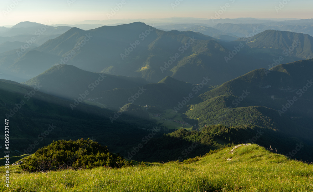 Sunrise mountains silhouette in the Julian Alps. Beautiful morning at the summit of the hills. 